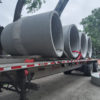 Manhole pipe arriving on a flatbed.