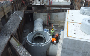 Crew members grouting 60-inch pipe at drop shaft 5.