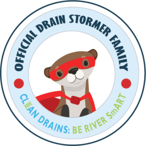 Clean Drains Official Drain Stormer Family Emblem with Otter (2) (1) Emblem that says 'Official Drain Stormer Family, Clean Drains: Be RIver Smart' with the face of the Clean Drains otter in the middle.