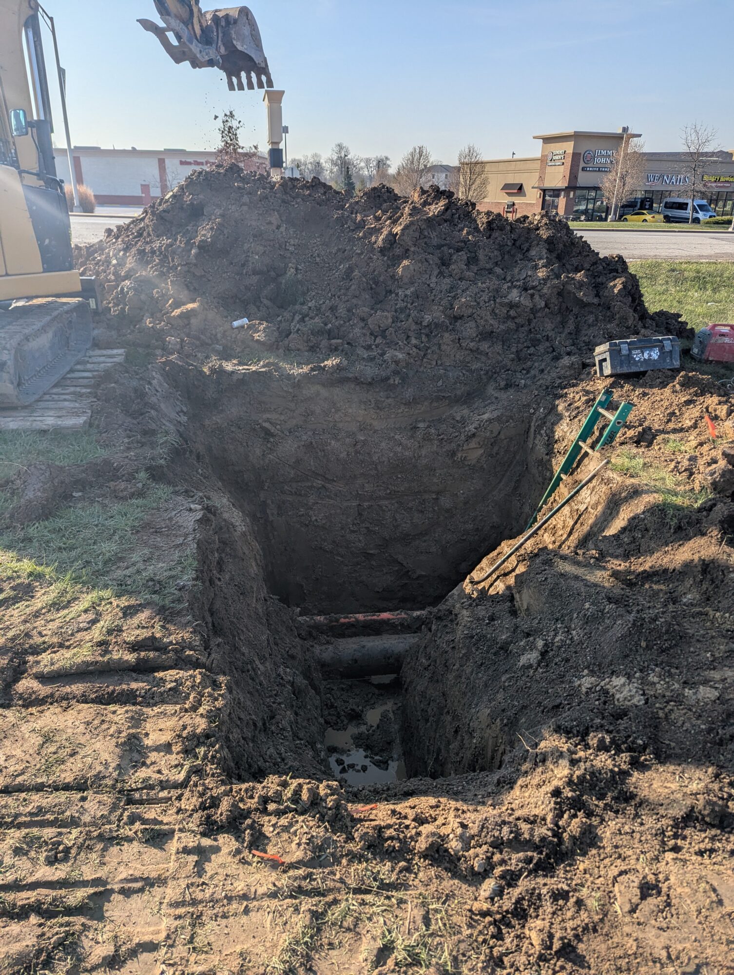 Exposed grass, after the bulldozer dug up the yard to expose the old water main.
