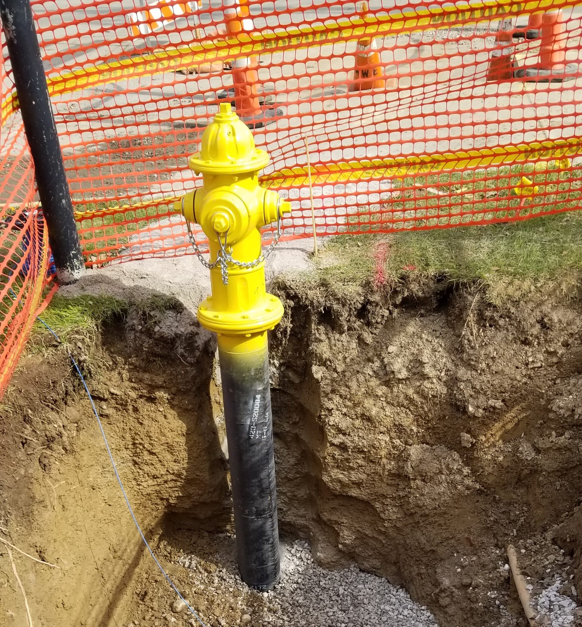 A yellow hydrant pipe exposed.
