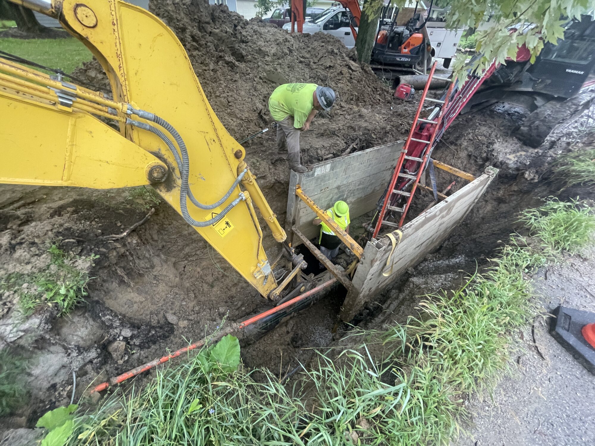 Bulldozer and men in a pit working on restoration.