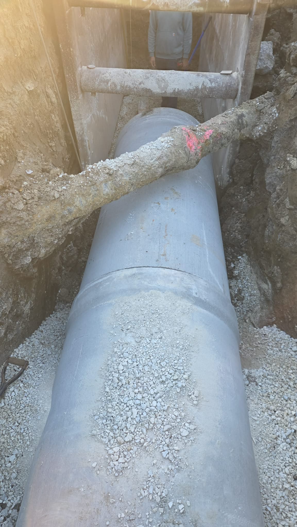 A white, large pipe undergood being isntalled.