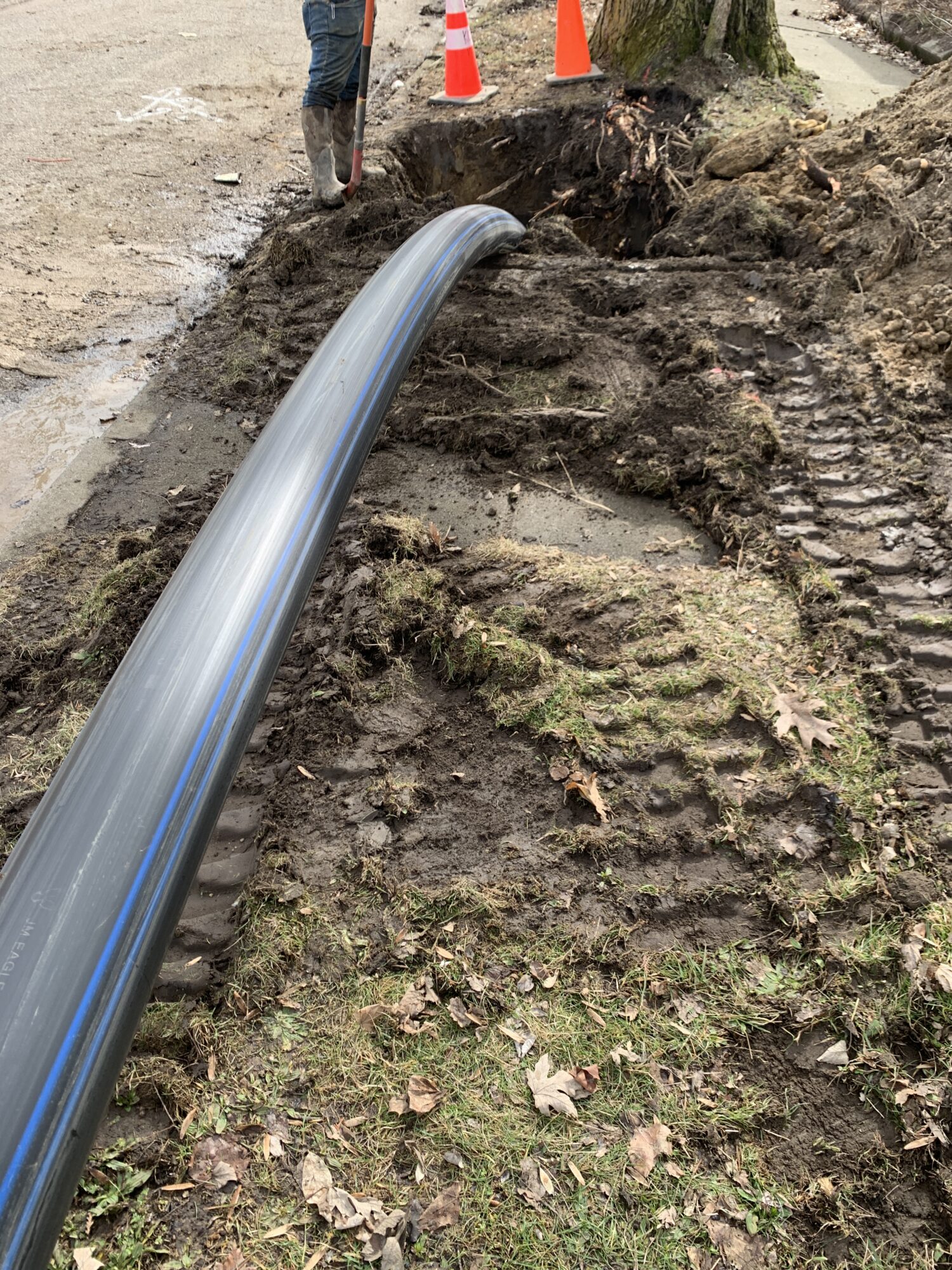 Crews pulling a new water main pipe into the ground.