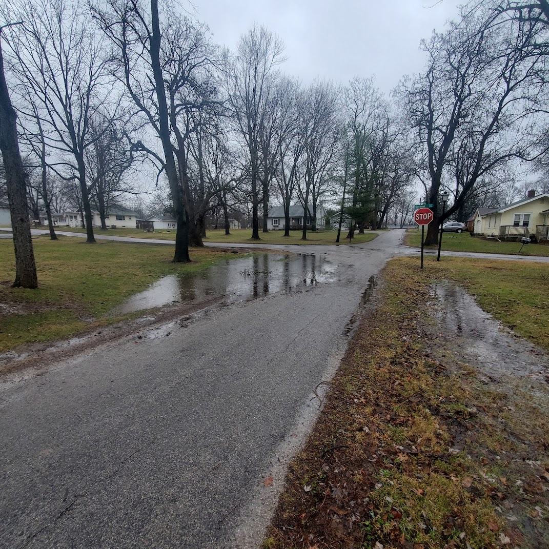 Neighborhood street with flooding in yards